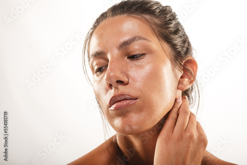 Close up of a girl touching her neck