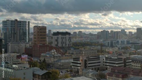 Top view of beautiful modern city in summer. Stock footage. Panorama of city with modern stylish architecture on horizon with cloudy sky