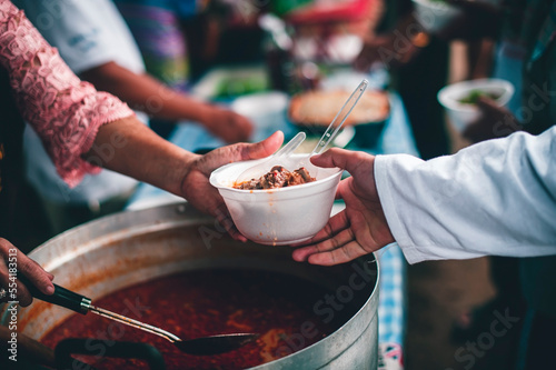 Humanitarian assistance from volunteers who share food for the hungry and poor : caring and donation concepts.