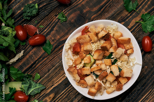 vegetable salad with crackers on a wooden table top.