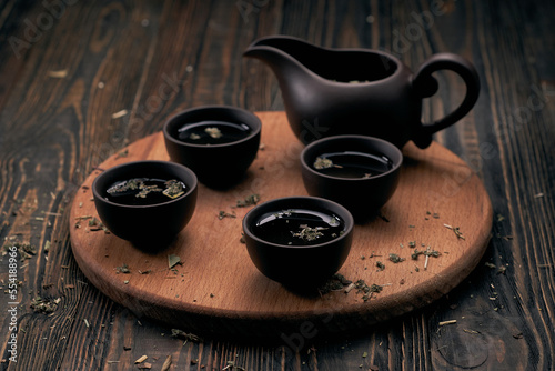 tea set and tea leaves on wooden kitchen board.