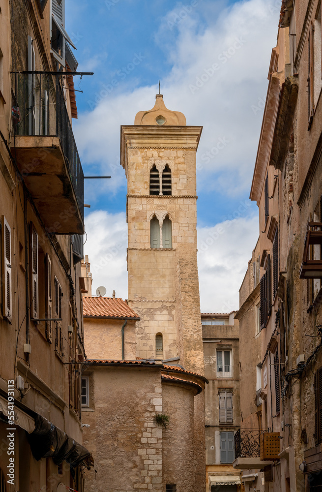 narrow street in the historic city center of Bonifacio with the church steeple of Sainte Marie Majeure Church