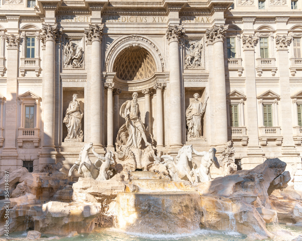 close-up view of the sculptures of the Trevi Fountain in downtown Rome in warm evening light
