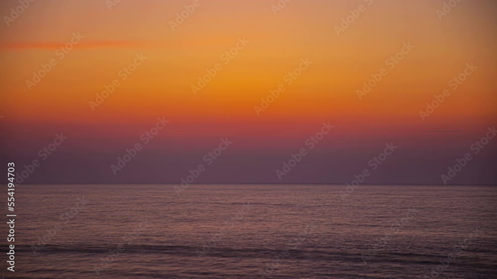 Time lapse of amazing sunrise over rippled ocean surface and sun rising in background Time lapse of amazing sunrise over rippled ocean surface and sun rising in background