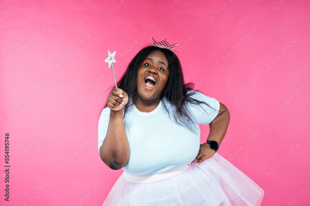 Image of a beautiful woman posing in a fairy costume on a pink background Image of a beautiful woman posing in a fairy costume on a pink background