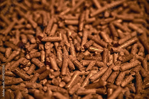Close-up of stacked wood pellets. Detailed shot of woodpellets. Pellet texture photo