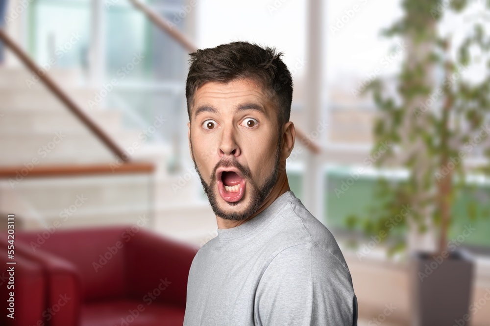 Fototapeta premium Surprised man posing on indoor background