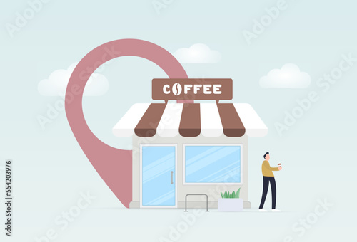Specialty coffee to go location. Man standing next to grab-and-go cafeteria point and drinking take away coffee from a paper cup photo