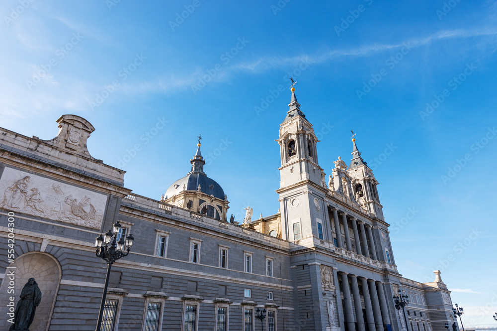 Facade of the Almudena Cathedral (Catedral de Santa Maria la Real de la Almudena) in Madrid downtown, Spain, southern Europe. Neo-Romanesque, neo-Gothic and neo-Classical style, 1883-1993.