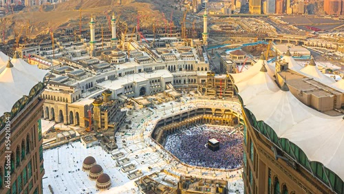 Time lapse wide angle of Muslim pilgrims circling around the holy Kaaba at day and praying inside al Masjid al Haram in Mecca, Saudi Arabia. Zoom in motion timelapse. Prores Full HD photo