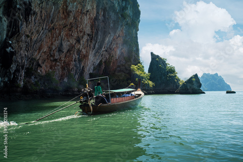 Traditional long thai boat near beautiful famous Phi Phi Islands, Thailand. Tourists sea trip, travel vacation in Thailand.