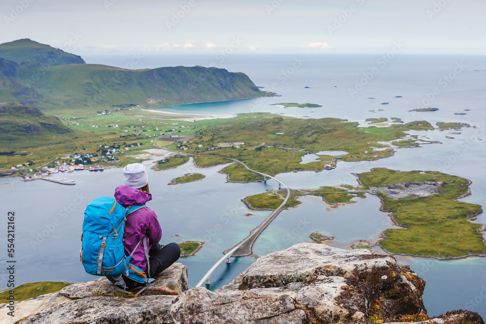 woman hiker enjoy the view on the cliff. Norway, Lofotens