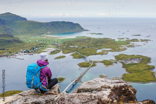 woman hiker enjoy the view on the cliff. Norway, Lofotens