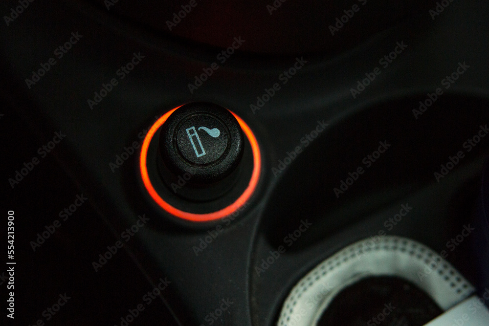 Closeup of a cigarette lighter inside a car.