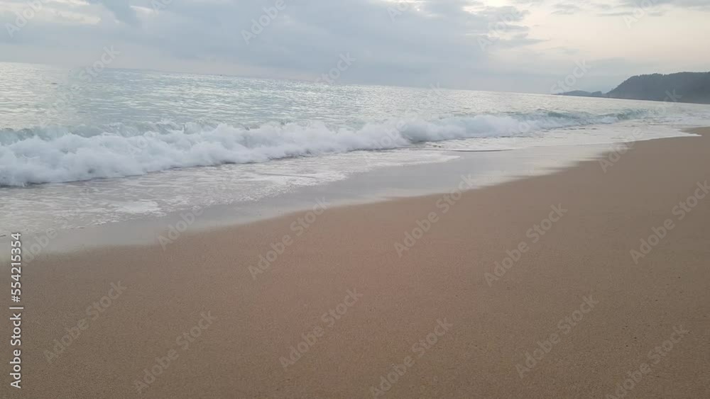 Waves of a restless turbulent ocean that scatter on the sandy beach and create white sea foam Waves of a restless turbulent ocean that scatter on the sandy beach and create white sea foam
