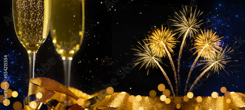 2024 Happy New Year holiday Greeting Card banner - Sparkling wine or champagne glasses, golden ribbon and fireworks on black night sky texture background