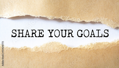 Share your goals message written under torn paper.