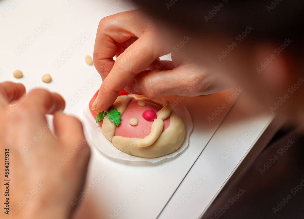 Preparation of steamed sandwich in the shape of Santa Claus.