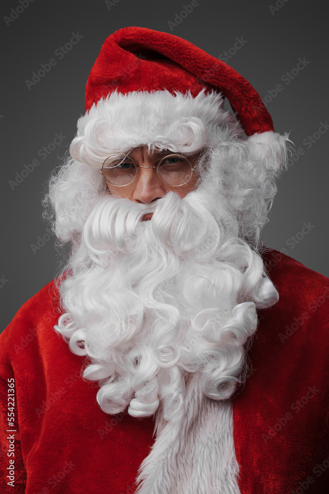 Portrait of santa claus with beard and red costume against grey background. Portrait of santa claus with beard and red costume against grey background.