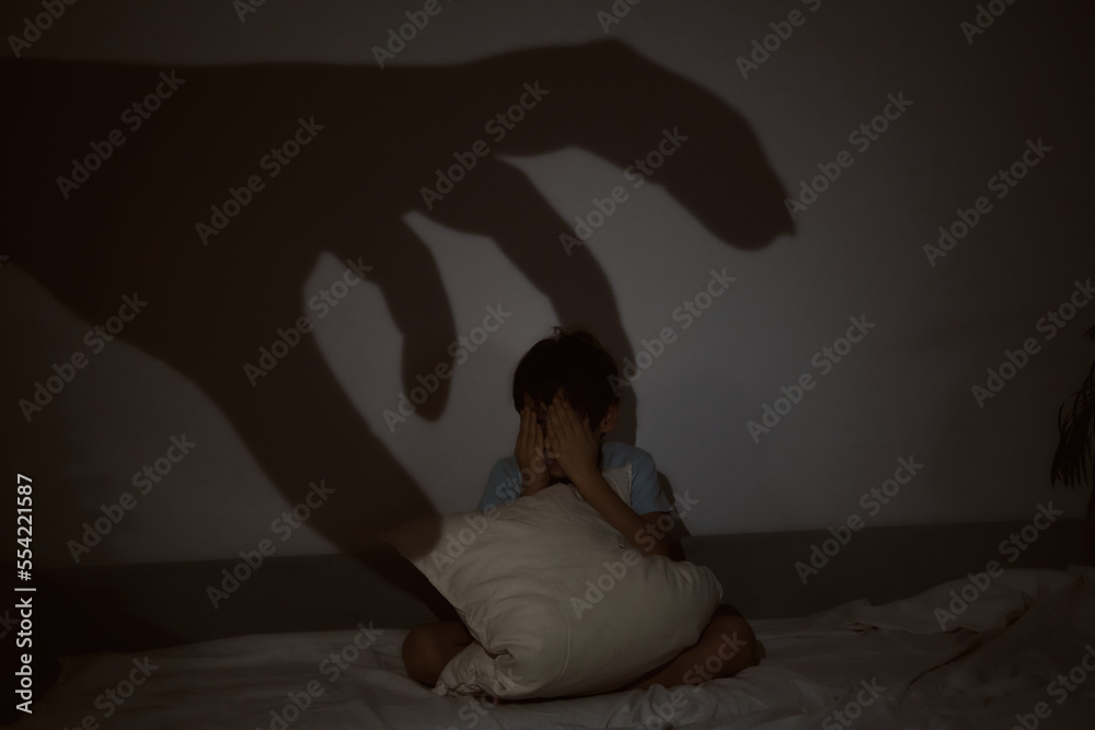 child cannot sleep because of the fear of the dark, the frightened boy hides under the pillow. insomnia, childish fear. child cannot sleep because of the fear of the dark, the frightened boy hides under the pillow. insomnia, childish fear.