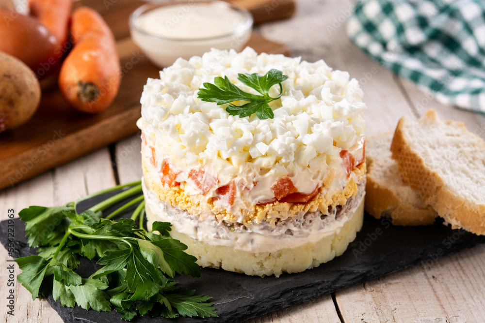 Russian salad or Olivier salad for Christmas dinner on wooden table Russian salad or Olivier salad for Christmas dinner on wooden table