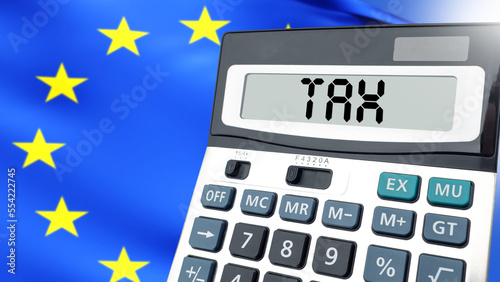 Calculator labeled taxes. Flag of European Union. Budget payments. Paying taxes in European Union. EU tax law. Payment of obligations to state. Duties on goods in European Union. 3d image. photo