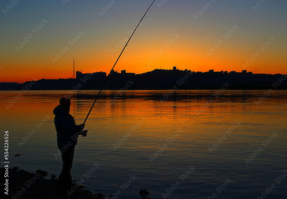 fishing on the lake at sunset