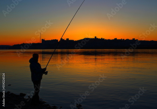 fishing on the lake at sunset