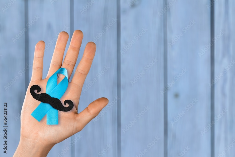 Fototapeta premium Prostate Cancer concept, hand holding Blue Ribbon