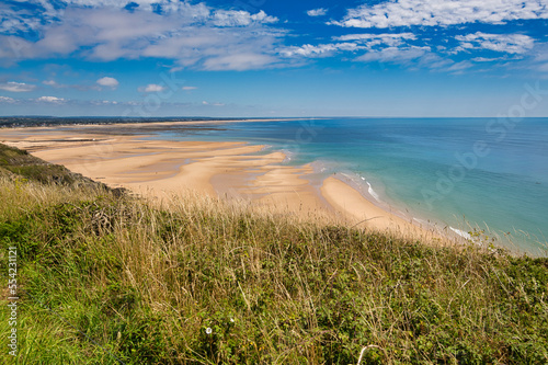 Scene of beach side with cloudy sky, saturated colors