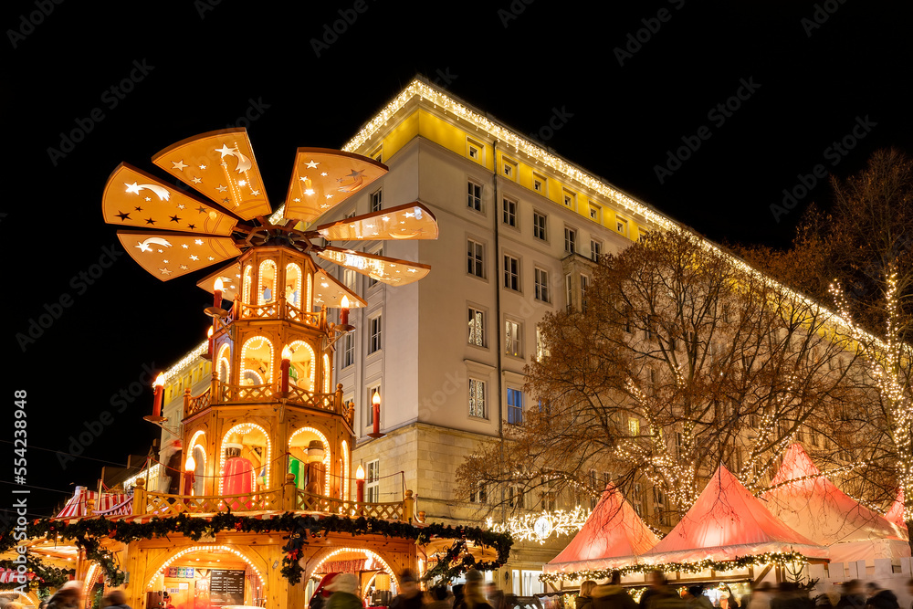 Beautiful traditional German Christmas Market square in Magdeburg city center Germany with Christmas Pyramide many carousel, tree lights and decoration. Christmas and new year celebration season