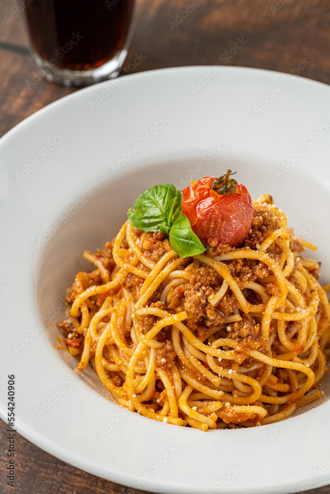Spaghetti with bolognese sauce on a white porcelain plate Spaghetti with bolognese sauce on a white porcelain plate