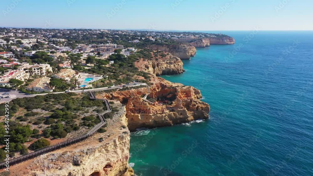 Beautiful aerial views of the seaside tourist town of Carvoeiro with cliff beaches and traditional Portuguese houses. Beautiful aerial views of the seaside tourist town of Carvoeiro with cliff beaches and traditional Portuguese houses.