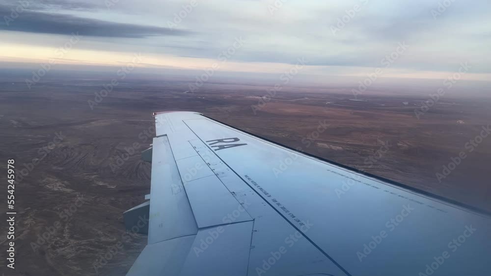 View from the window of a flying plane to the beautiful clouds. Air transport concept. View from the window of a flying plane to the beautiful clouds. Air transport concept.