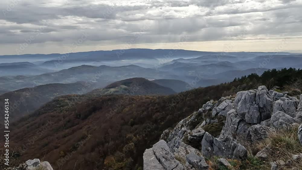 Beautiful view of misty mountain peaks in autumn season in the morning. Nature scenery, fall foggy landscape.