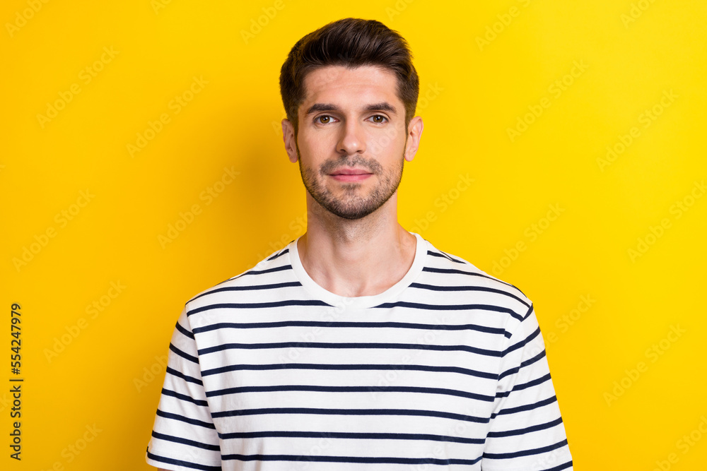 Portrait photo of young business owner guy student wear striped stylish t-shirt bristle beard look concentrated isolated on yellow color background Portrait photo of young business owner guy student wear striped stylish t-shirt bristle beard look concentrated isolated on yellow color background