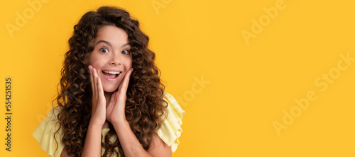 express positive emotion. haircare and skincare. hairdresser. surprised kid curly hair. Child face, horizontal poster, teenager girl portrait, banner with copy space.