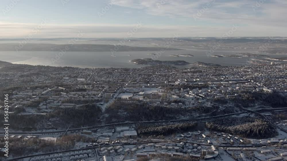 Winter drone scene over the city of Oslo in Norway - drone pans to the right over the city and suburbs Winter drone scene over the city of Oslo in Norway - drone pans to the right over the city and suburbs