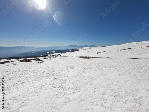 Scenic view of snow covered alpine meadows and Koralpe mountains seen from Ladinger Spitz, Saualpe, Lavanttal Alps, Carinthia, Austria, Europe. Untouched field of snow. Ski touring snowshoeing tourism