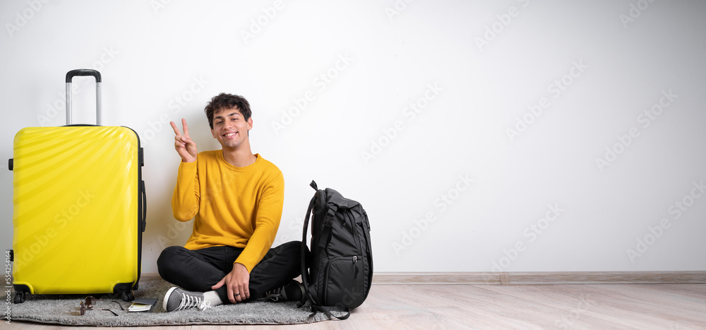 Young arabic man with suitcase showing number two with fingers or victory sign isolated over white background Young arabic man with suitcase showing number two with fingers or victory sign isolated over white background