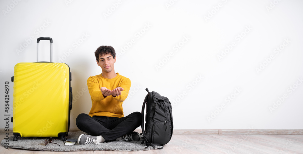 Traveler man with suitcase holding palms in cupped shape over isolated white background. Concepts of sharing, giving, offering, taking care, protection. Traveler man with suitcase holding palms in cupped shape over isolated white background. Concepts of sharing, giving, offering, taking care, protection.