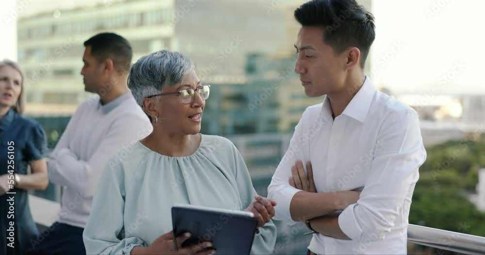 Tablet, businessman and senior manager on a rooftop planning a digital strategy for online target audience. Teamwork, diversity or woman in leadership talking, coaching or speaking to Japanese worker Tablet, businessman and senior manager on a rooftop planning a digital strategy for online target audience. Teamwork, diversity or woman in leadership talking, coaching or speaking to Japanese worker