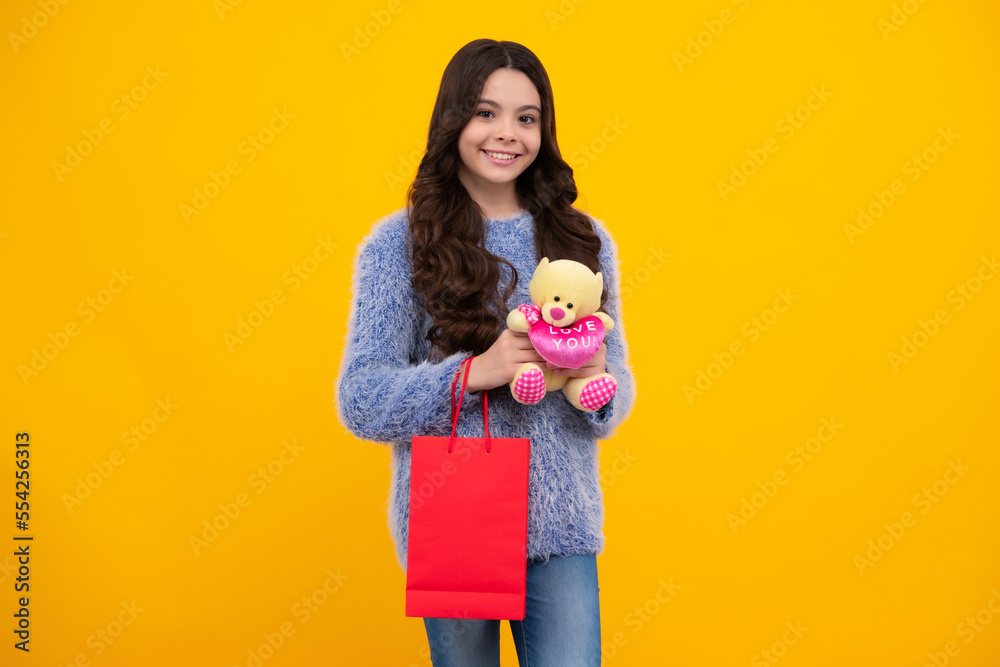 Shopping bags in the kids hands. Teen girl after shopping. Purchases, black friday, discounts and sale concept. Happy teenager, positive and smiling emotions of teen girl. Shopping bags in the kids hands. Teen girl after shopping. Purchases, black friday, discounts and sale concept. Happy teenager, positive and smiling emotions of teen girl.