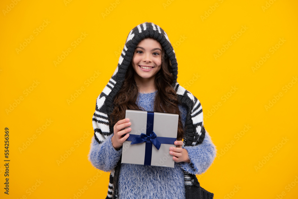 Teenager child with gift box. Present for holidays. Happy birthday, Valentines day, New Year or Christmas. Kid hold present box. Happy teenage girl, positive and smiling emotions.
