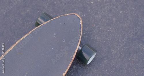 The movement of the longboard board on the road. Type of transport in the city. Eco-friendly walking on the sidewalk. photo