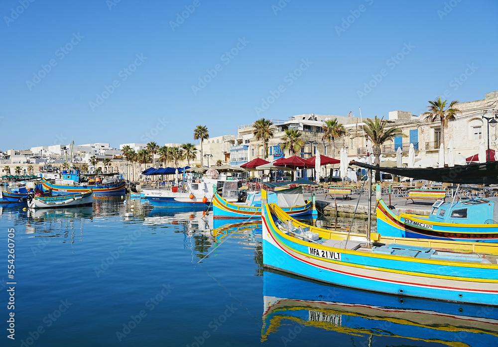 Colorful fishing boats in port of european Marsaxlokk town in Malta