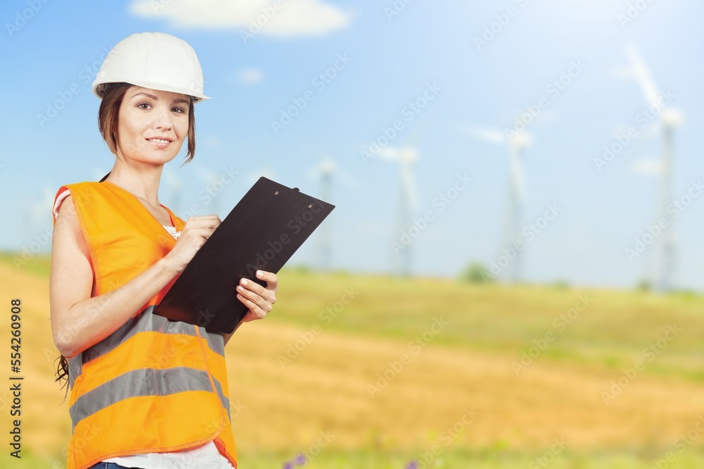 Young engineer in helmet using digital tablet Young engineer in helmet using digital tablet