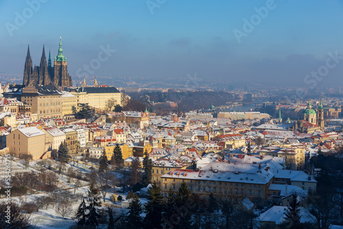 Christmas Snowy Prague City with gothic Castle from Hill Petrin in the sunny Day, Czech republic
