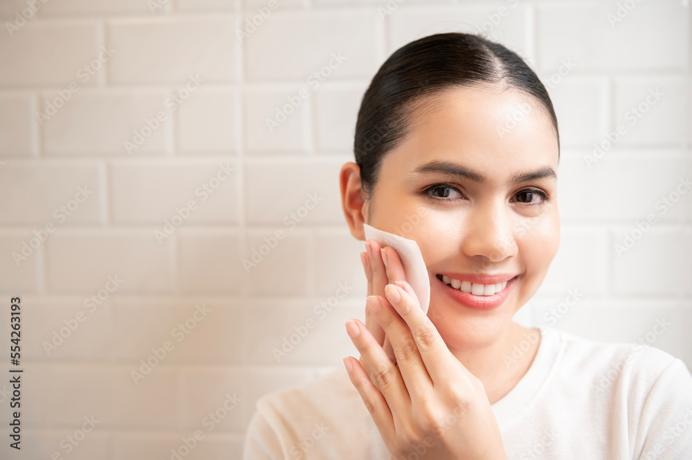Young woman cleaning removing makeup on her face in bathroom at home , beauty wellness concept Young woman cleaning removing makeup on her face in bathroom at home , beauty wellness concept