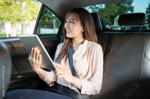 Young asian beautiful businesswoman working with tablet in the car © tonefotografia